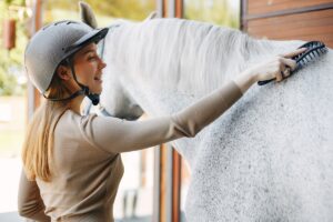 Beautiful woman standing with a horse